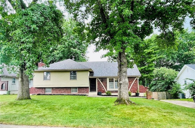 1004 SW Twilight Ln, Blue Springs, MO 64015 - split level home featuring a chimney and brick siding
