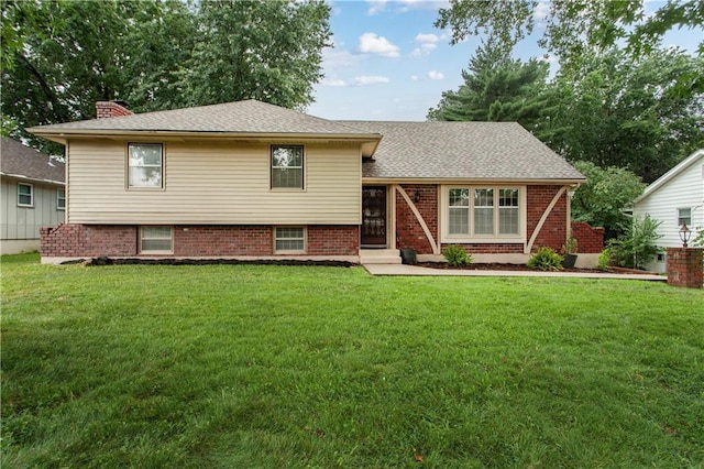1004 SW Twilight Ln, Blue Springs, MO 64015 - split level home featuring a front yard, a chimney, and brick siding