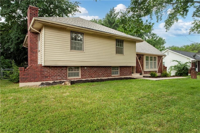 1004 SW Twilight Ln, Blue Springs, MO 64015 - view of front facade with a chimney, a front yard, and a shingled roof
