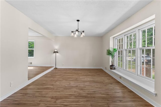 1004 SW Twilight Ln, Blue Springs, MO 64015 - spare room with a chandelier and wood finished floors