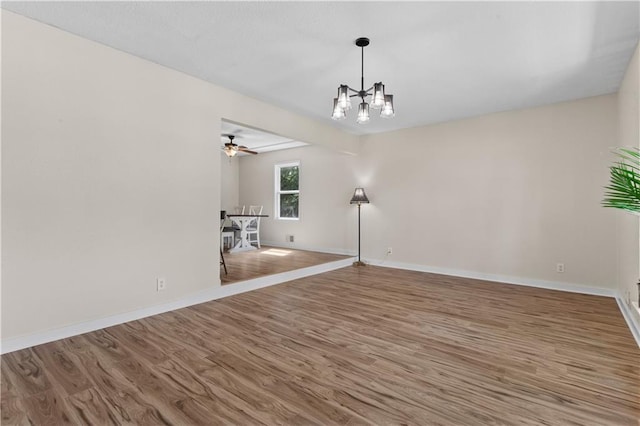 1004 SW Twilight Ln, Blue Springs, MO 64015 - unfurnished living room with a chandelier, wood finished floors, and ceiling fan