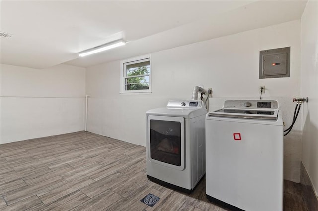 1004 SW Twilight Ln, Blue Springs, MO 64015 - laundry area with electric panel, washer and dryer, and wood finished floors