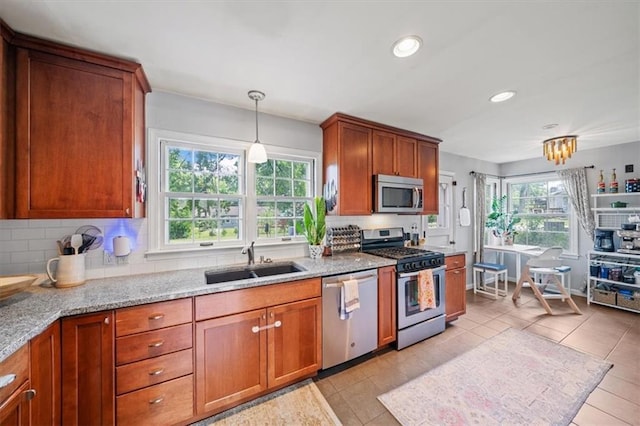 4717 W 76th St, Prairie Village, KS 66208 - kitchen featuring appliances with stainless steel finishes, brown cabinetry, backsplash, and recessed lighting