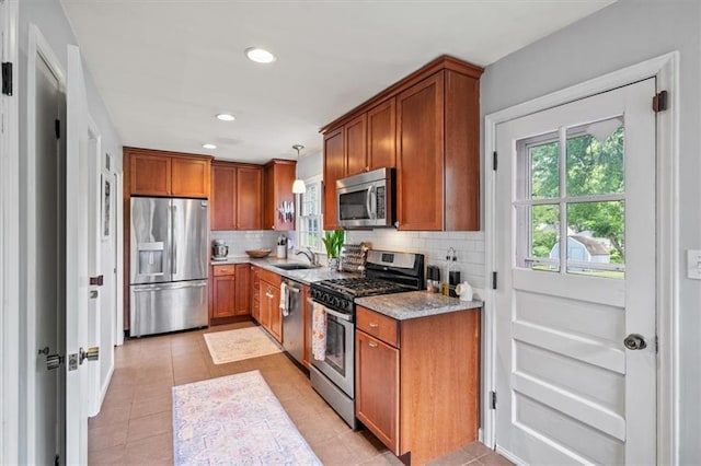 4717 W 76th St, Prairie Village, KS 66208 - kitchen with appliances with stainless steel finishes, brown cabinets, tasteful backsplash, and recessed lighting