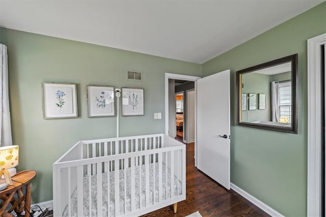 4717 W 76th St, Prairie Village, KS 66208 - bedroom featuring dark wood-type flooring and a nursery area