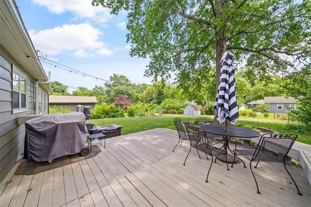 4717 W 76th St, Prairie Village, KS 66208 - wooden deck with a grill, a shed, outdoor dining area, a yard, and a jacuzzi