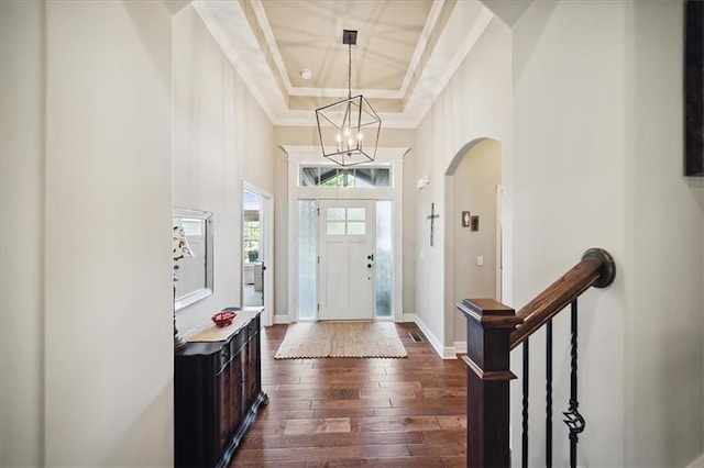 9158 W 178th Ter, Overland Park, KS 66013 - foyer entrance with dark wood-type flooring, a chandelier, arched walkways, ornamental molding, and a raised ceiling