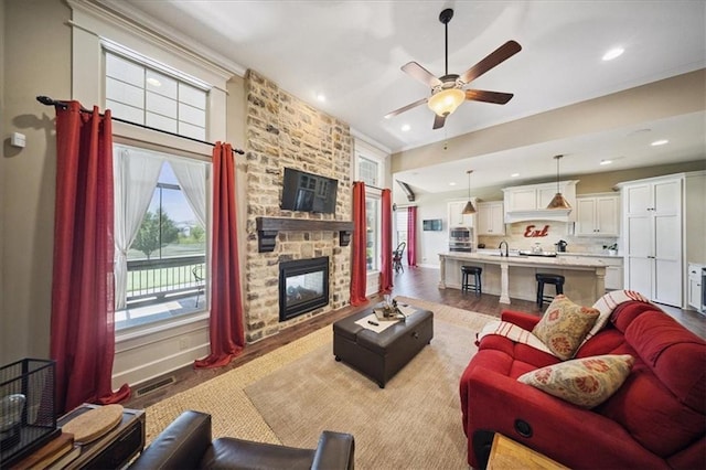 9158 W 178th Ter, Overland Park, KS 66013 - living area featuring a ceiling fan, light wood-style flooring, a stone fireplace, and recessed lighting