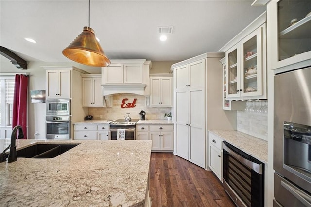 9158 W 178th Ter, Overland Park, KS 66013 - kitchen with wine cooler, appliances with stainless steel finishes, glass insert cabinets, dark wood finished floors, and hanging light fixtures