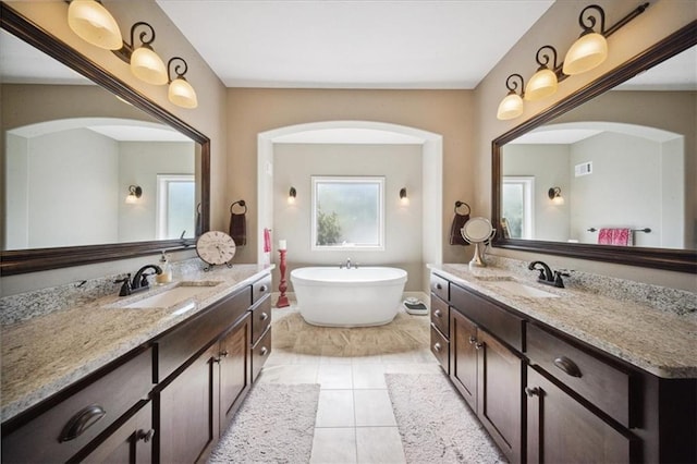 9158 W 178th Ter, Overland Park, KS 66013 - full bath with two vanities, a freestanding tub, and tile patterned flooring