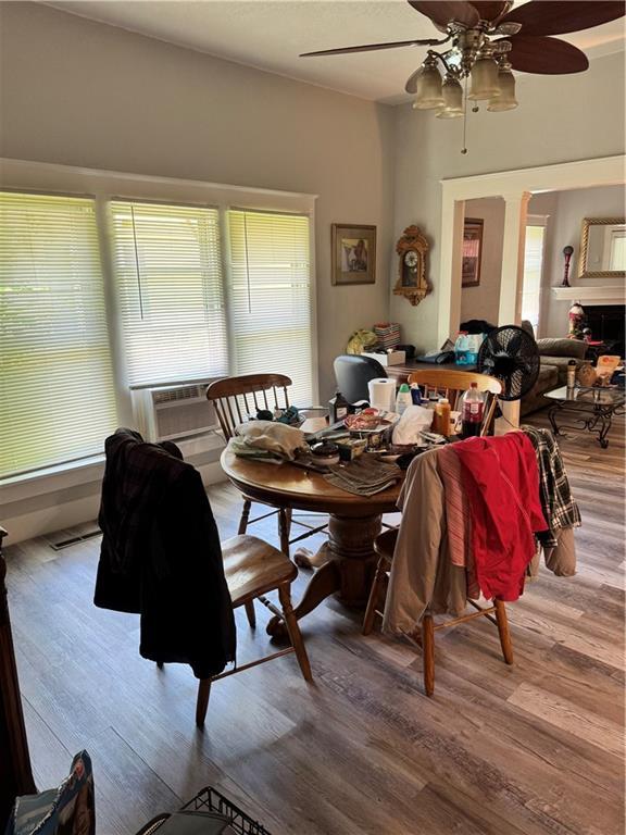 406 S 2nd St, Odessa, MO 64076 - dining space featuring wood finished floors, ceiling fan, and cooling unit