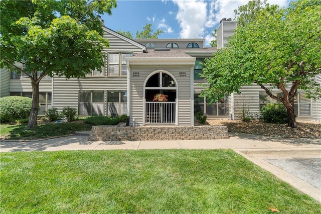 8858 W 106th Ter, Overland Park, KS 66212 - view of front facade with a front lawn and a chimney