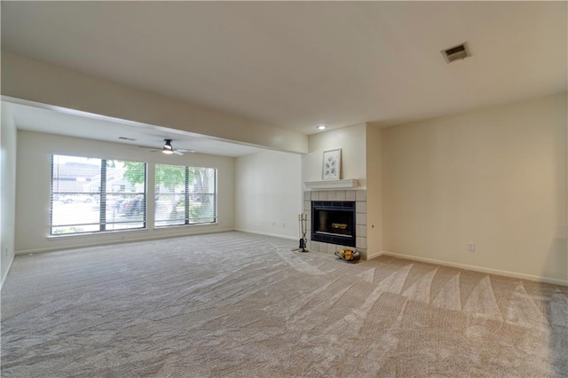 8858 W 106th Ter, Overland Park, KS 66212 - unfurnished living room with light colored carpet, a tile fireplace, and ceiling fan