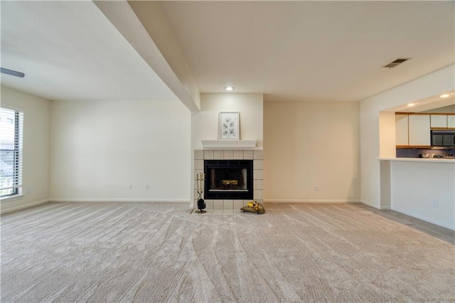 8858 W 106th Ter, Overland Park, KS 66212 - unfurnished living room with recessed lighting, a tile fireplace, and light colored carpet