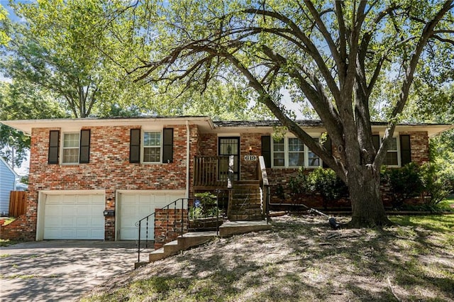 619 E 109th Ter, Kansas City, MO 64131 - view of front of property with brick siding, driveway, and an attached garage