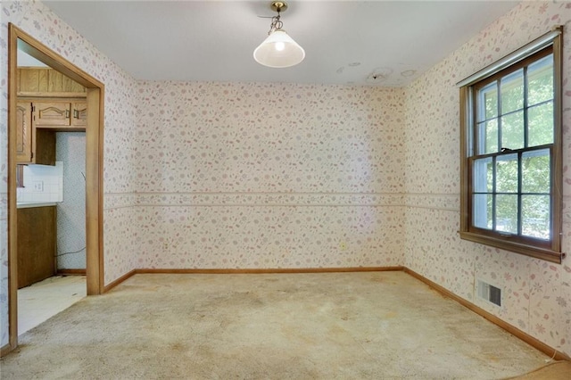 619 E 109th Ter, Kansas City, MO 64131 - unfurnished room with wallpapered walls, plenty of natural light, and light colored carpet