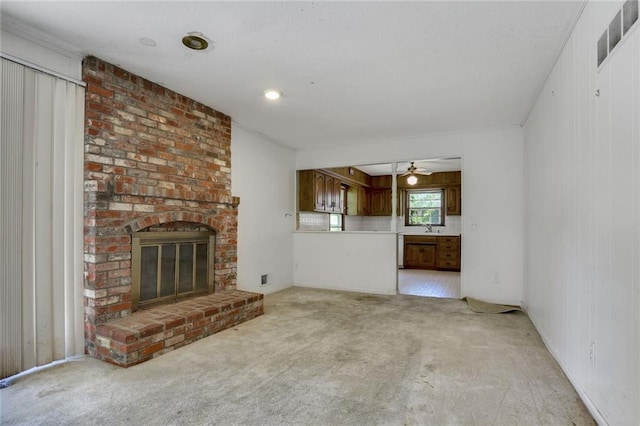 619 E 109th Ter, Kansas City, MO 64131 - unfurnished living room featuring a ceiling fan, light carpet, and a fireplace