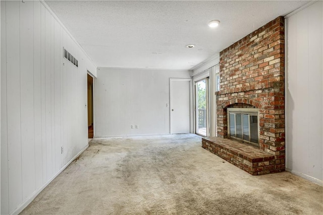 619 E 109th Ter, Kansas City, MO 64131 - unfurnished living room featuring carpet floors, a brick fireplace, a textured ceiling, and wood walls