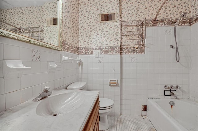 619 E 109th Ter, Kansas City, MO 64131 - bathroom with wallpapered walls, tile walls, vanity, tile patterned flooring, and bathtub / shower combination