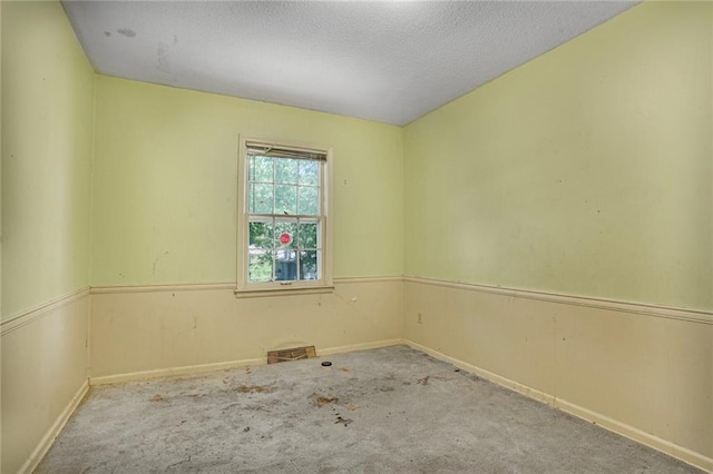 619 E 109th Ter, Kansas City, MO 64131 - carpeted spare room with a textured ceiling and baseboards