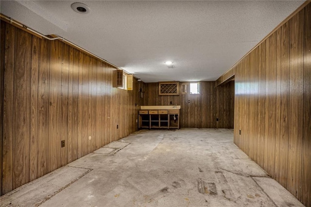 619 E 109th Ter, Kansas City, MO 64131 - below grade area with a textured ceiling and wooden walls
