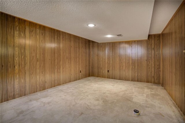 619 E 109th Ter, Kansas City, MO 64131 - spare room with carpet floors, a textured ceiling, and wood walls