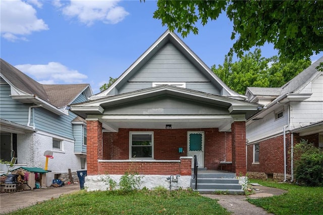 3344 Chestnut Ave, Kansas City, MO 64128 - view of front of property featuring covered porch and brick siding