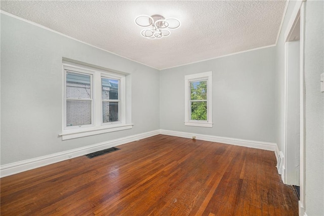 3344 Chestnut Ave, Kansas City, MO 64128 - spare room with wood finished floors, a textured ceiling, crown molding, and a chandelier