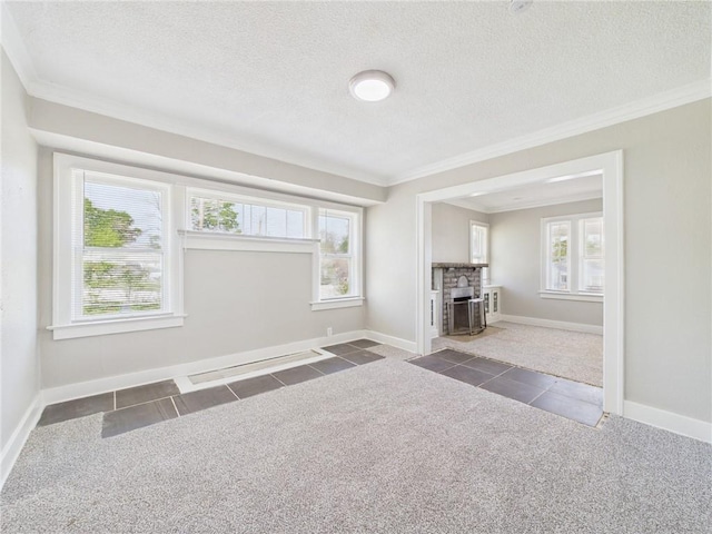3904 Bales Ave, Kansas City, MO 64130 - unfurnished living room with crown molding, tile patterned flooring, healthy amount of natural light, a textured ceiling, and a fireplace