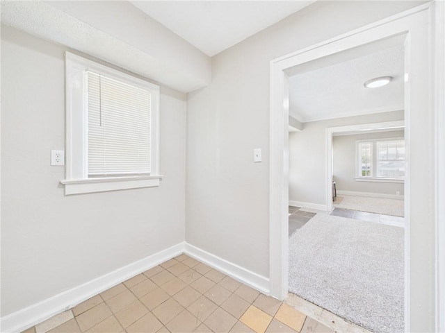 3904 Bales Ave, Kansas City, MO 64130 - empty room with tile patterned floors and ornamental molding