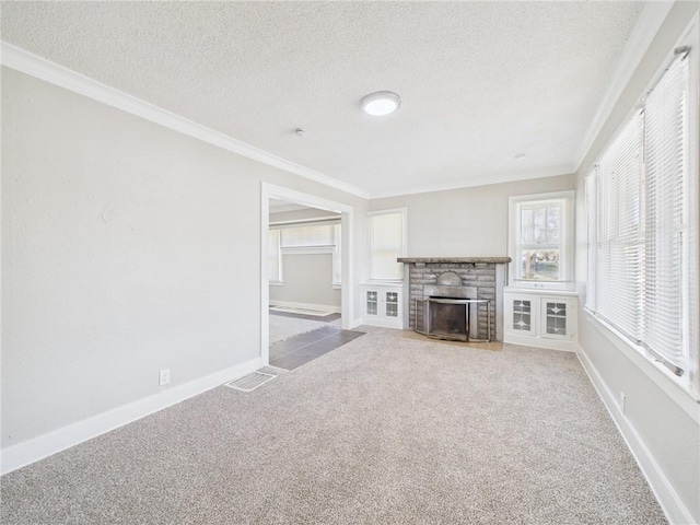 3904 Bales Ave, Kansas City, MO 64130 - unfurnished living room featuring a textured ceiling, carpet floors, crown molding, and a fireplace