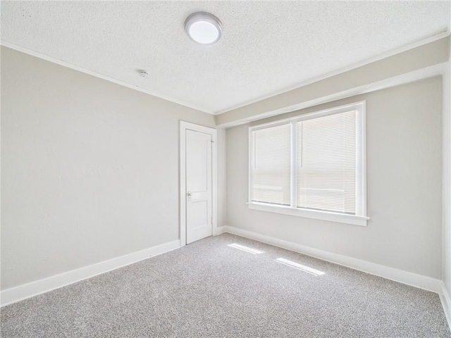 3904 Bales Ave, Kansas City, MO 64130 - carpeted spare room with a textured ceiling and ornamental molding