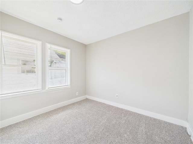 3904 Bales Ave, Kansas City, MO 64130 - empty room featuring carpet floors and a smoke detector