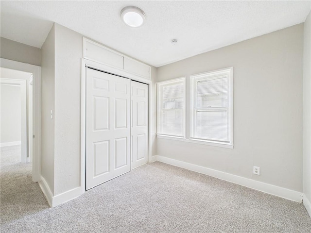 3904 Bales Ave, Kansas City, MO 64130 - unfurnished bedroom featuring carpet and a closet