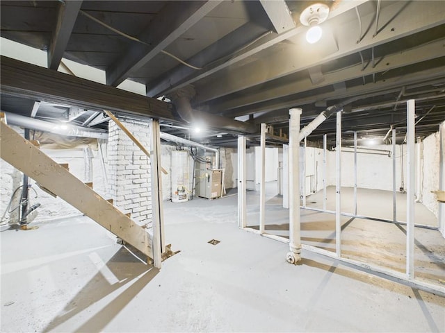 3904 Bales Ave, Kansas City, MO 64130 - unfinished basement featuring water heater and heating unit