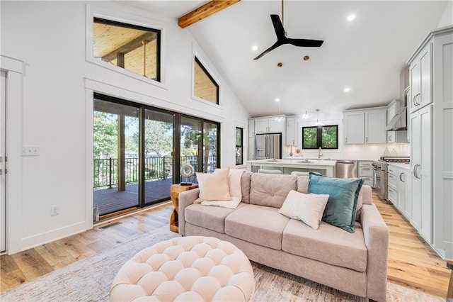 48 M St, Lake Lotawana, MO 64086 - living area featuring beam ceiling, high vaulted ceiling, ceiling fan, light wood finished floors, and recessed lighting