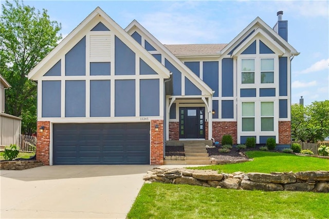 11245 S Penrose St, Olathe, KS 66061 - view of front of house with a garage, brick siding, concrete driveway, and a chimney