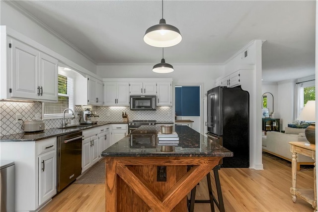 11245 S Penrose St, Olathe, KS 66061 - kitchen with stainless steel appliances, light wood-style floors, white cabinetry, dark stone countertops, and tasteful backsplash