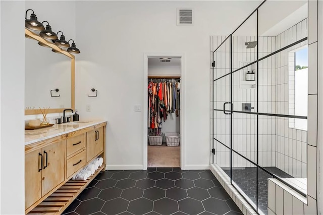 11245 S Penrose St, Olathe, KS 66061 - full bath featuring vanity, tile patterned flooring, a shower stall, and a walk in closet