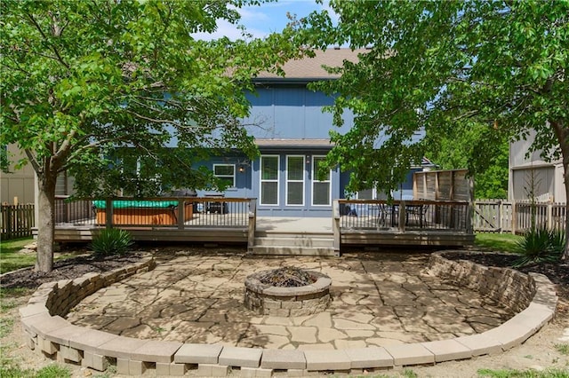 11245 S Penrose St, Olathe, KS 66061 - rear view of property with an outdoor fire pit, a patio, and a wooden deck