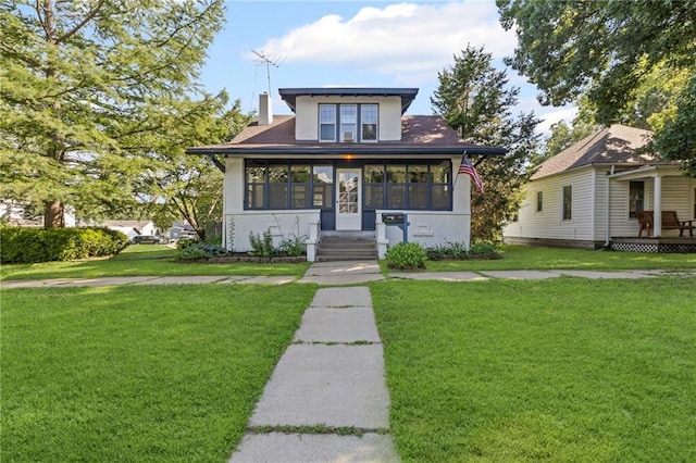 309 E Miami St, Paola, KS 66071 - bungalow-style house with a front yard, stucco siding, and a chimney