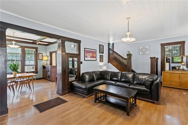 309 E Miami St, Paola, KS 66071 - living room featuring light wood-type flooring, crown molding, and stairway