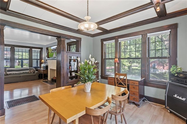 309 E Miami St, Paola, KS 66071 - dining space with ornate columns, light wood-type flooring, coffered ceiling, crown molding, and beam ceiling