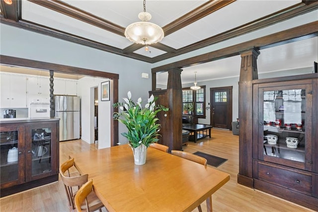 309 E Miami St, Paola, KS 66071 - dining room featuring decorative columns, crown molding, light wood-style floors, and a chandelier