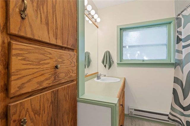 309 E Miami St, Paola, KS 66071 - full bathroom featuring a baseboard radiator, vanity, and curtained shower
