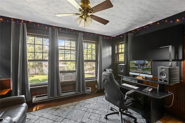 309 E Miami St, Paola, KS 66071 - office area with wood finished floors, a ceiling fan, cooling unit, and a baseboard radiator