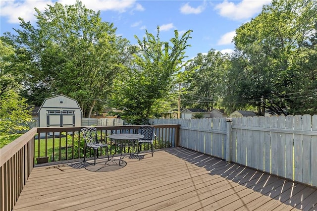 309 E Miami St, Paola, KS 66071 - wooden deck featuring a storage shed, a fenced backyard, and outdoor dining area