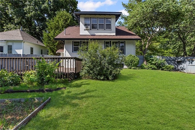 309 E Miami St, Paola, KS 66071 - back of property with stucco siding, a fenced backyard, and a deck