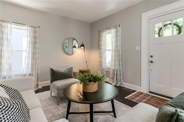 521 Tracy Ave, Kansas City, MO 64016 - living area featuring healthy amount of natural light and wood finished floors