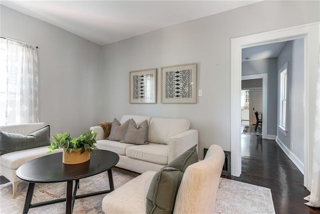 521 Tracy Ave, Kansas City, MO 64016 - living area featuring healthy amount of natural light and dark wood-style flooring